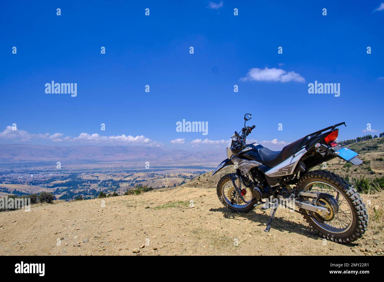 Detail of a motorcycle parked on the road during a trip to the interior of the country. Stock Photo