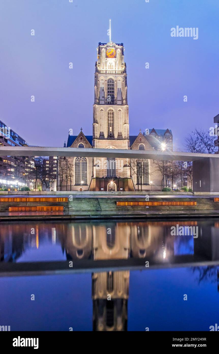 Rotterdam, The Netherlands, January 2, 2023: Saint Lawrence church, or Laurenskerk, reflecting in the water of Delftsevaart canal in the blue hour bef Stock Photo