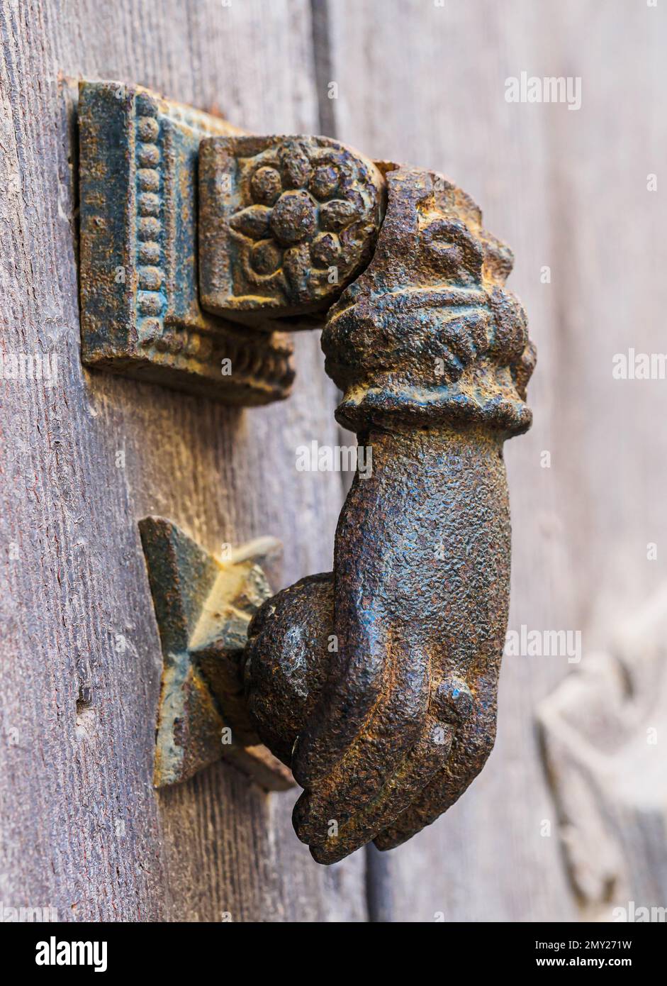Metal knocker on old wooden door Stock Photo