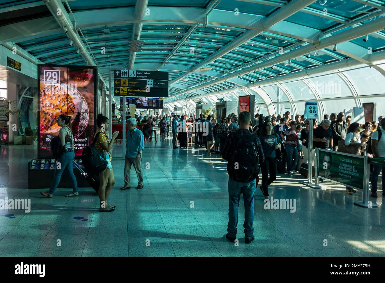 The Santos Dumont airport departure room passenger terminal crowded with passengers waiting for boarding his flights in an early summer morning. Stock Photo
