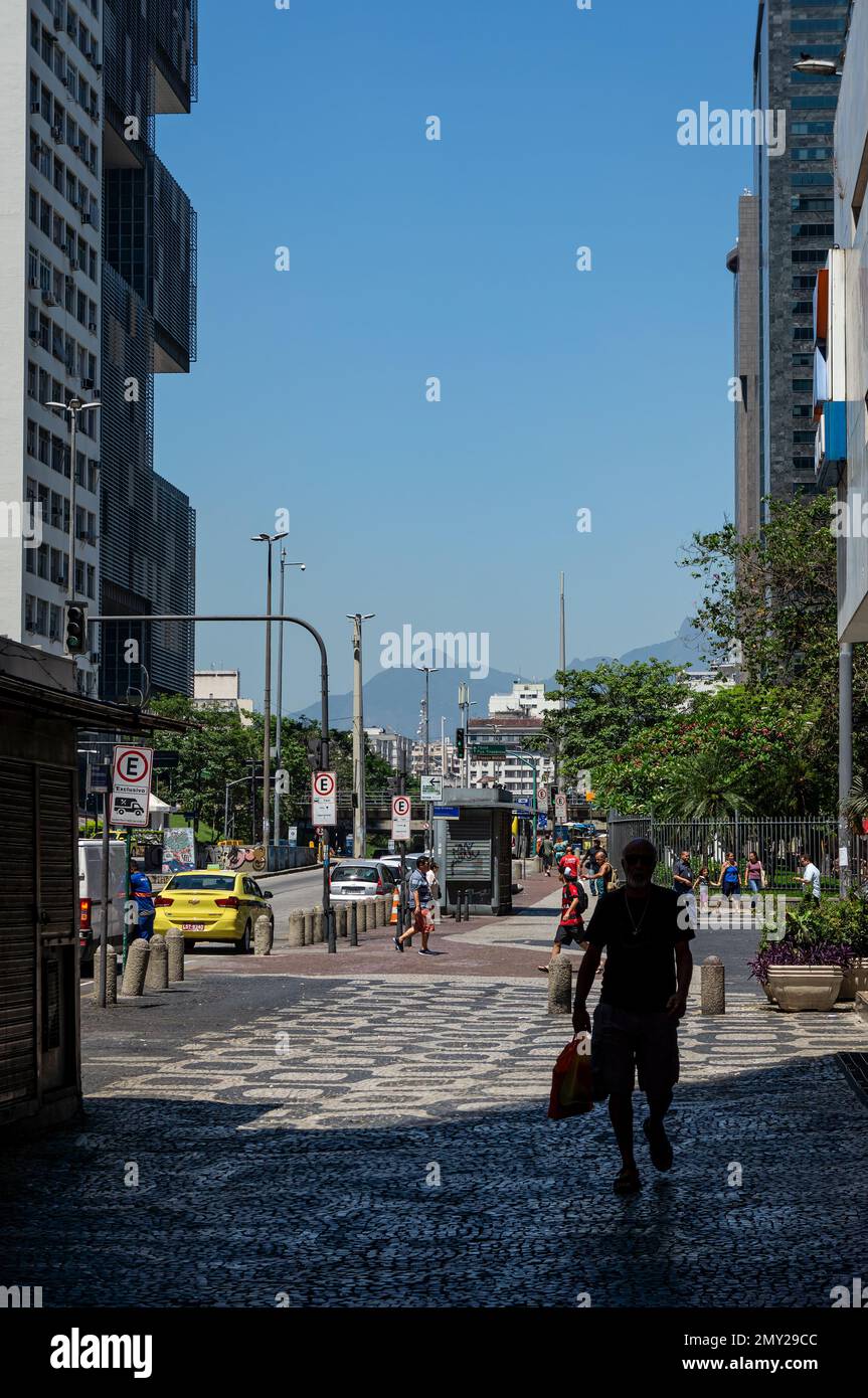 The wide sidewalk of Almirante Barroso avenue right at Caixa Cultural Center building and nearby Largo da Carioca square under summer sunny blue sky. Stock Photo