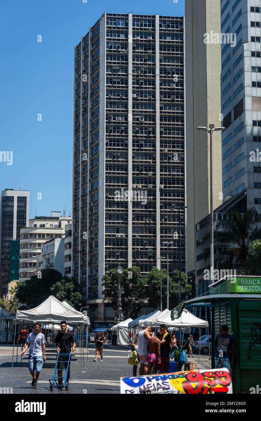 View of Largo da Carioca building tower block as saw from Largo da Carioca square in populated Centro district under summer morning sunny blue sky. Stock Photo
