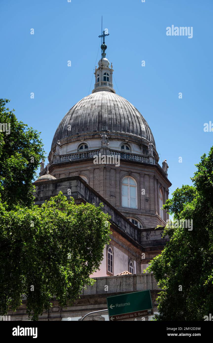 Partial view of the backside main dome of Candelaria church in downtown with some green vegetation trees around under summer sunny clear blue sky. Stock Photo