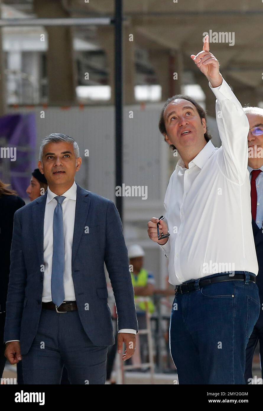 French digital businessman Xavier Niel, left, and his companion