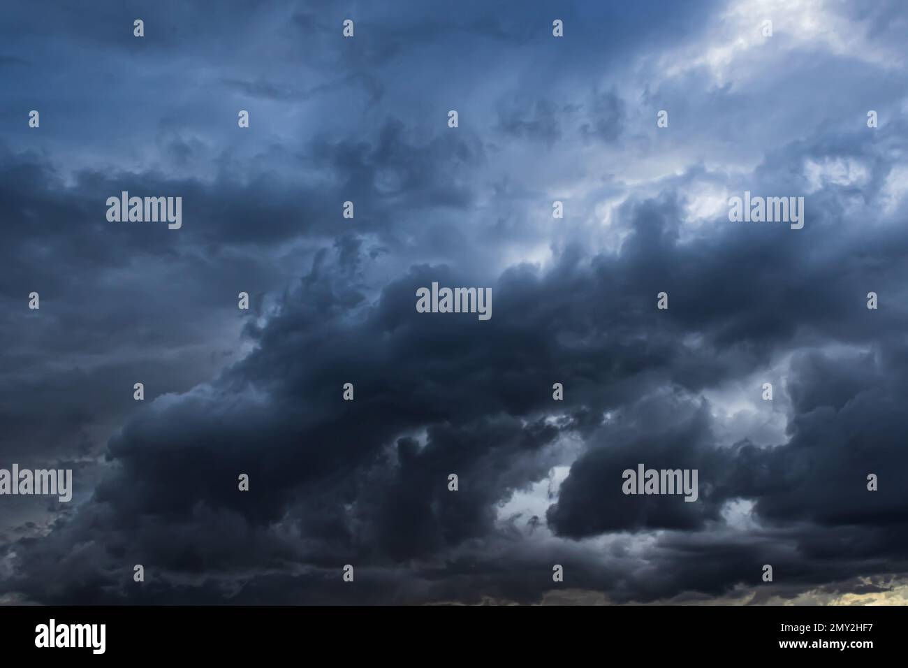 Dark ominous storm clouds create ethereal background element. Stock Photo