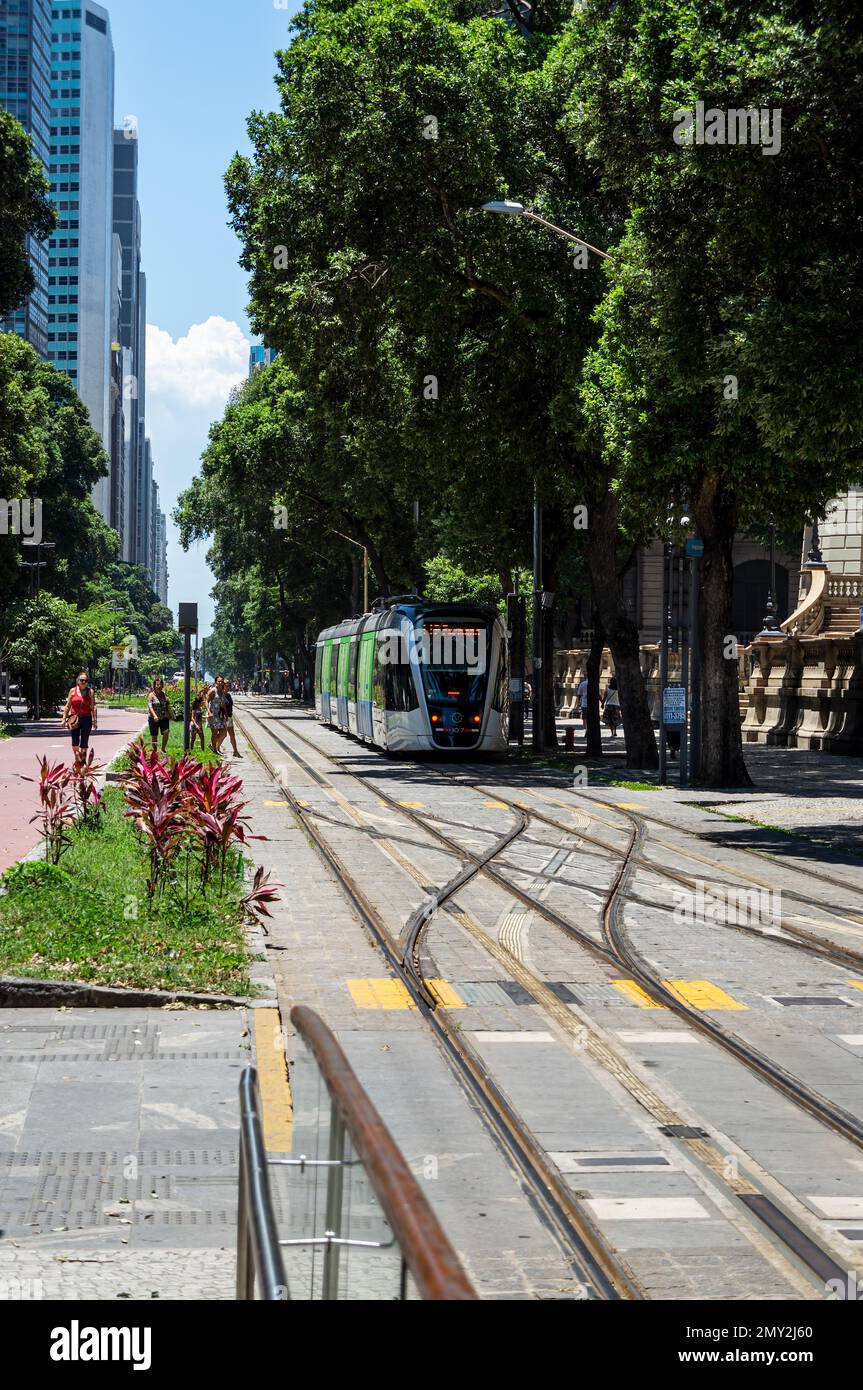 A VLT Carioca tram passing by a track switch located nearby Cinelandia tram stop at Floriano Peixoto square in Centro district under summer afternoon. Stock Photo