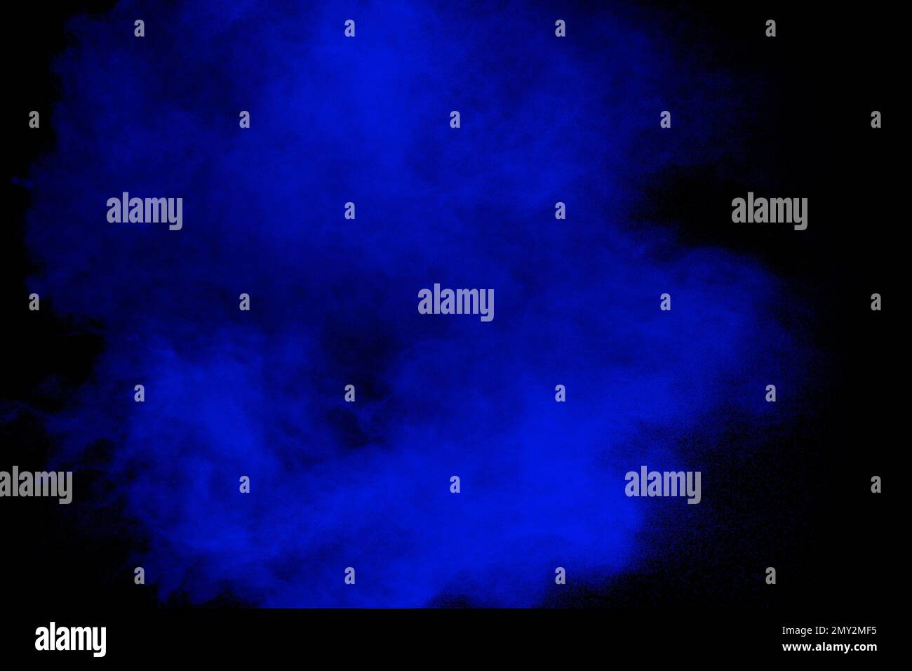 Blue powder explosion cloud on black background.Launched blue dust