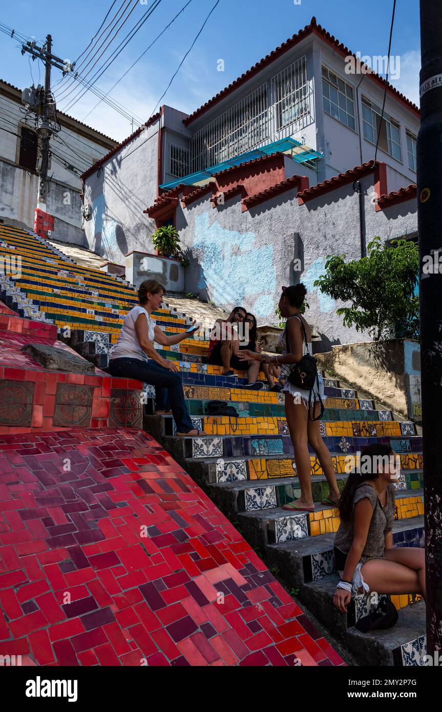 Tourists enjoying some time at colorful decorated Selaron Steps in Santa Teresa district nearby Ladeira de Santa Teresa street in a summer blue sky. Stock Photo
