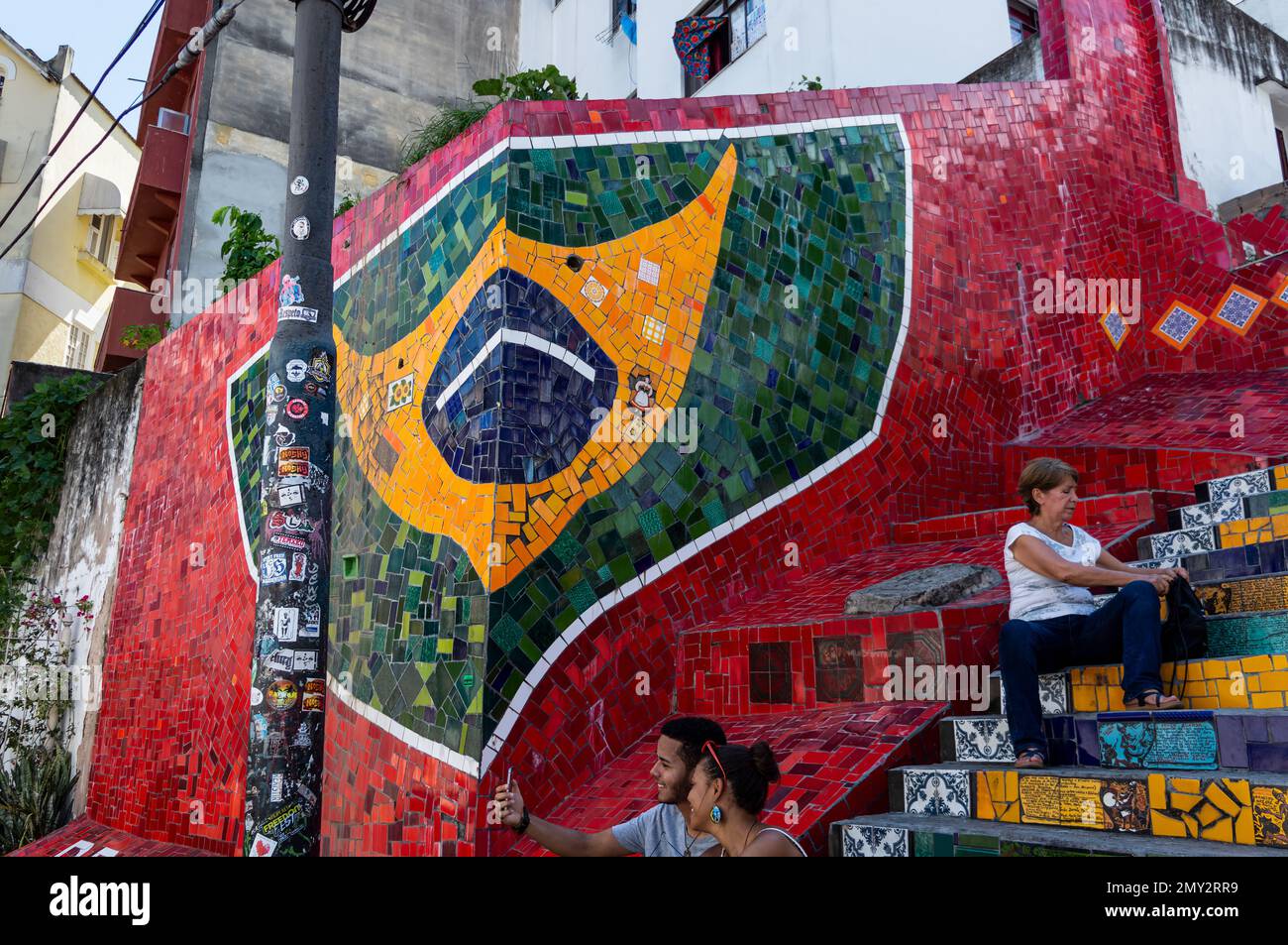 The mosaic tiles of the Brazilian flag at Selaron Steps in Santa Teresa district nearby Ladeira de Santa Teresa street in a summer afternoon sunny day Stock Photo