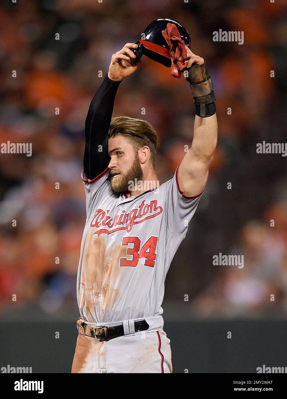 Washington Nationals' Bryce Harper wipes his face as he stands by second  base during the eighth inning of a baseball game against the Baltimore  Orioles, Monday, Aug. 22, 2016, in Baltimore. The