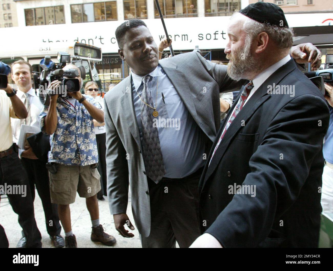 FILE In this Aug. 19, 2002, file photo, Carmel Cato, center, reaches