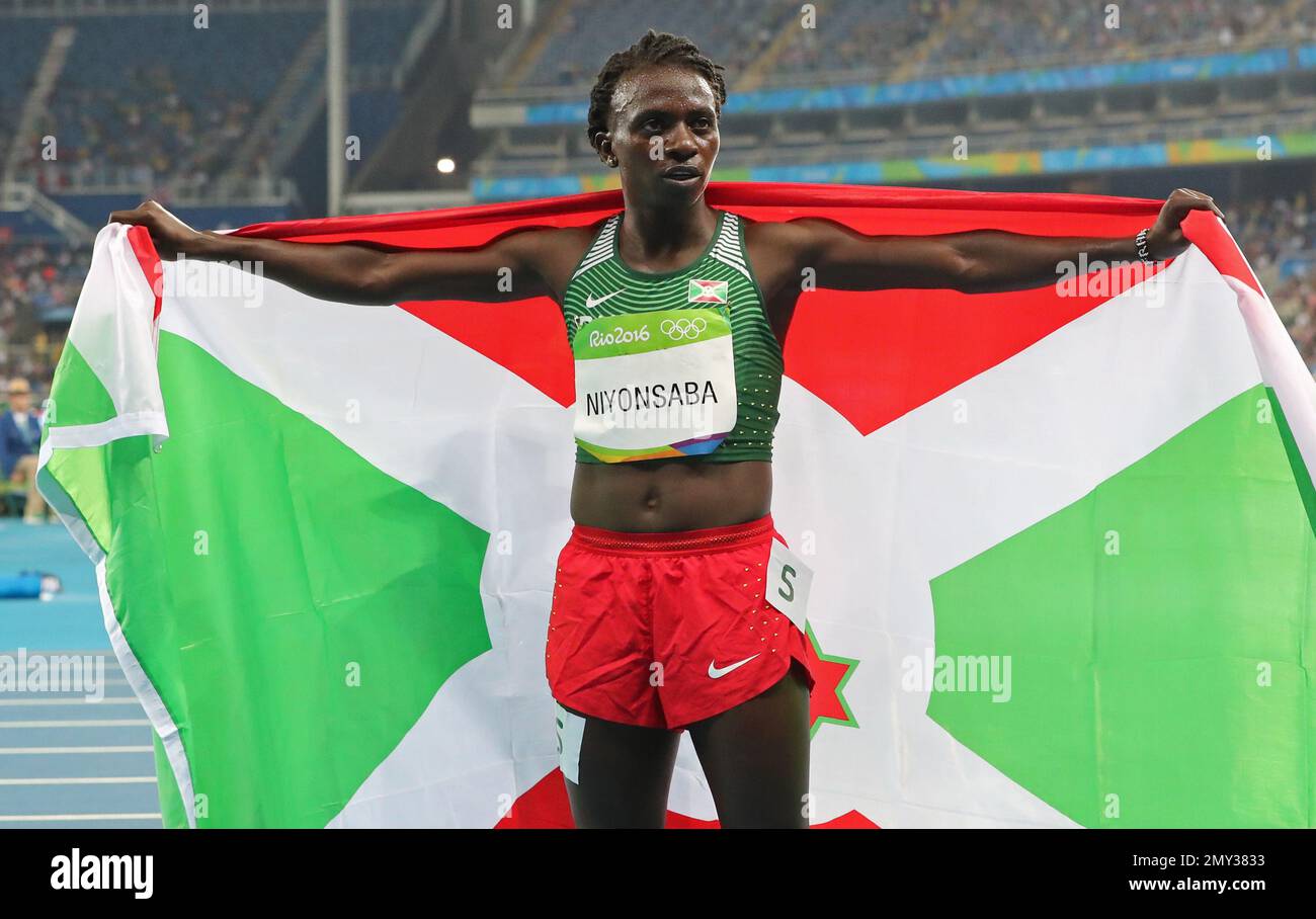 Burundi's Francine Niyonsaba celebrates with her national flag after