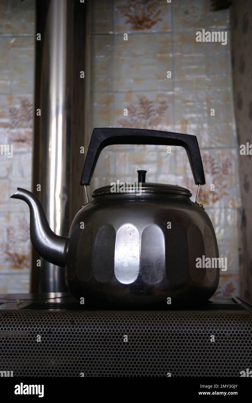 old kettle on an old gas stove Stock Photo