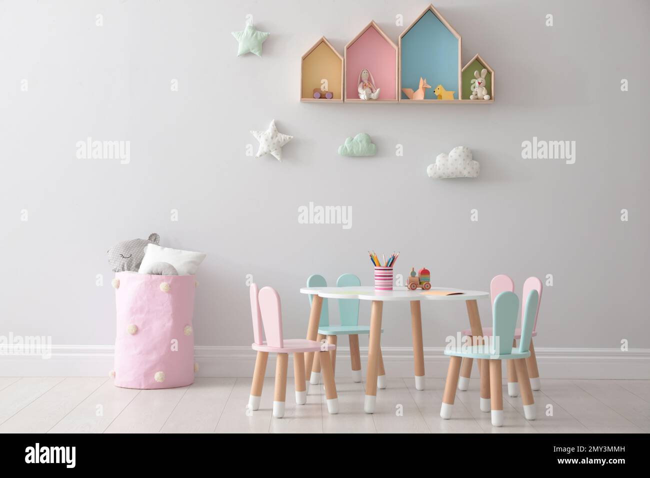 House shaped shelves and little table with chairs in children's room ...
