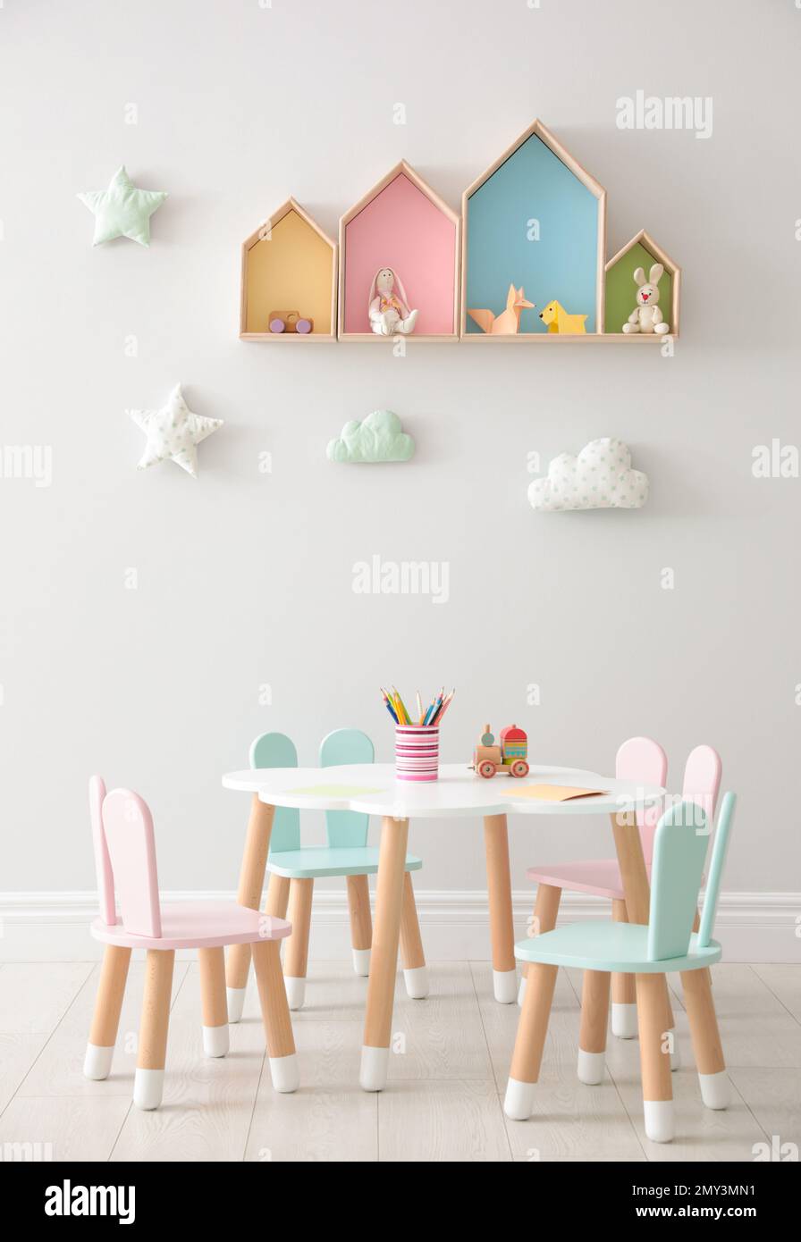 House shaped shelves and little table with chairs in children's room ...