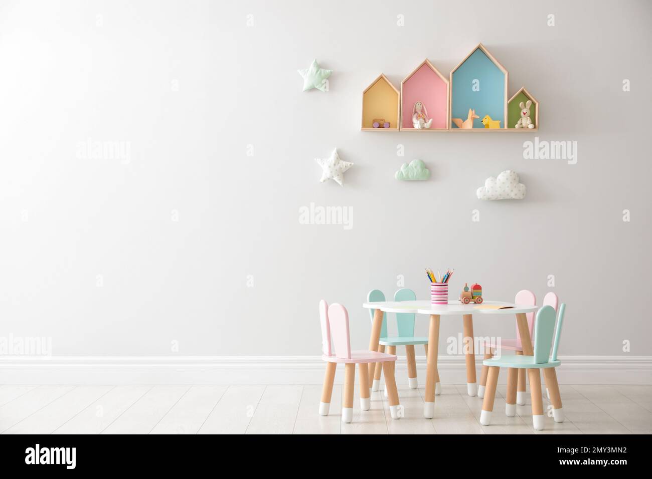 House shaped shelves and little table with chairs in children's room ...