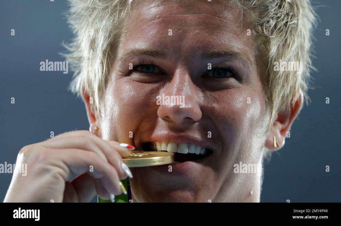 Poland's gold medal winner Anita Wlodarczyk bites her gold medal after