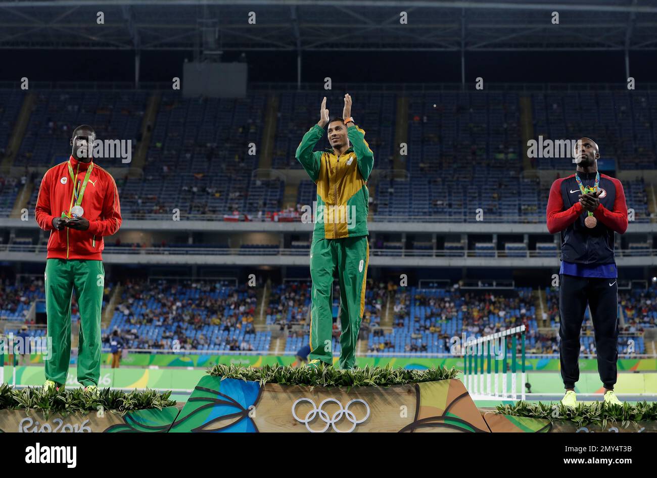 South Africa's gold medal winner Wayde Van Niekerk is flanked by