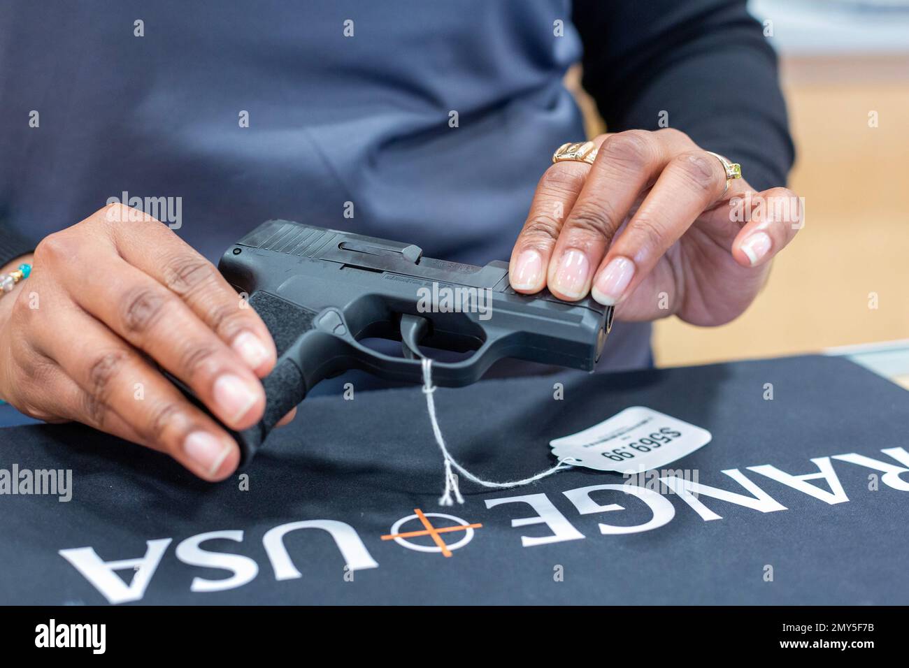 Southgate, Michigan - A saleswoman displays a Sig Sauer pistol at Range