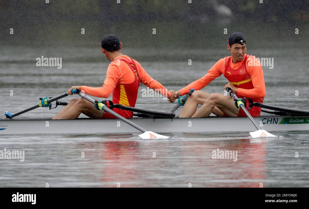 Sun Man and Wang Chunxin, of China, rest after competing in the men's