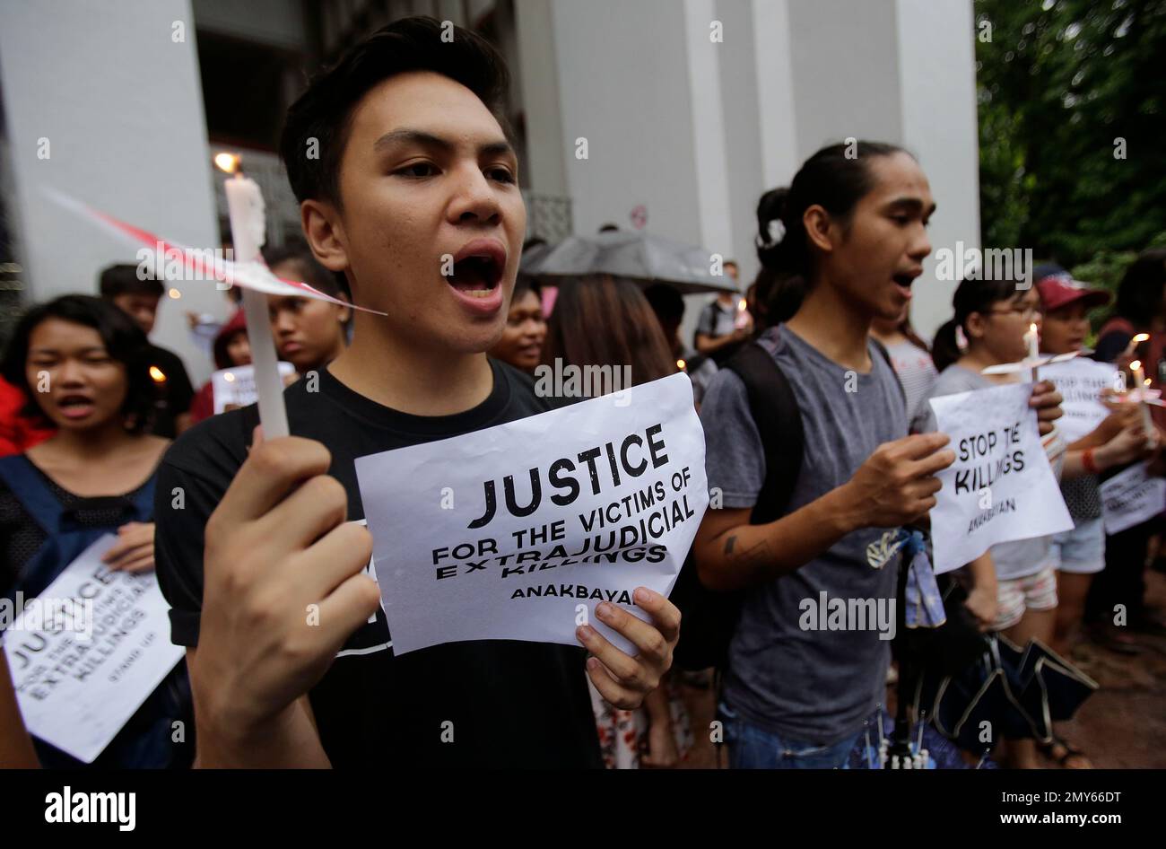 Filipino student activists holding candles shout slogans to call for ...