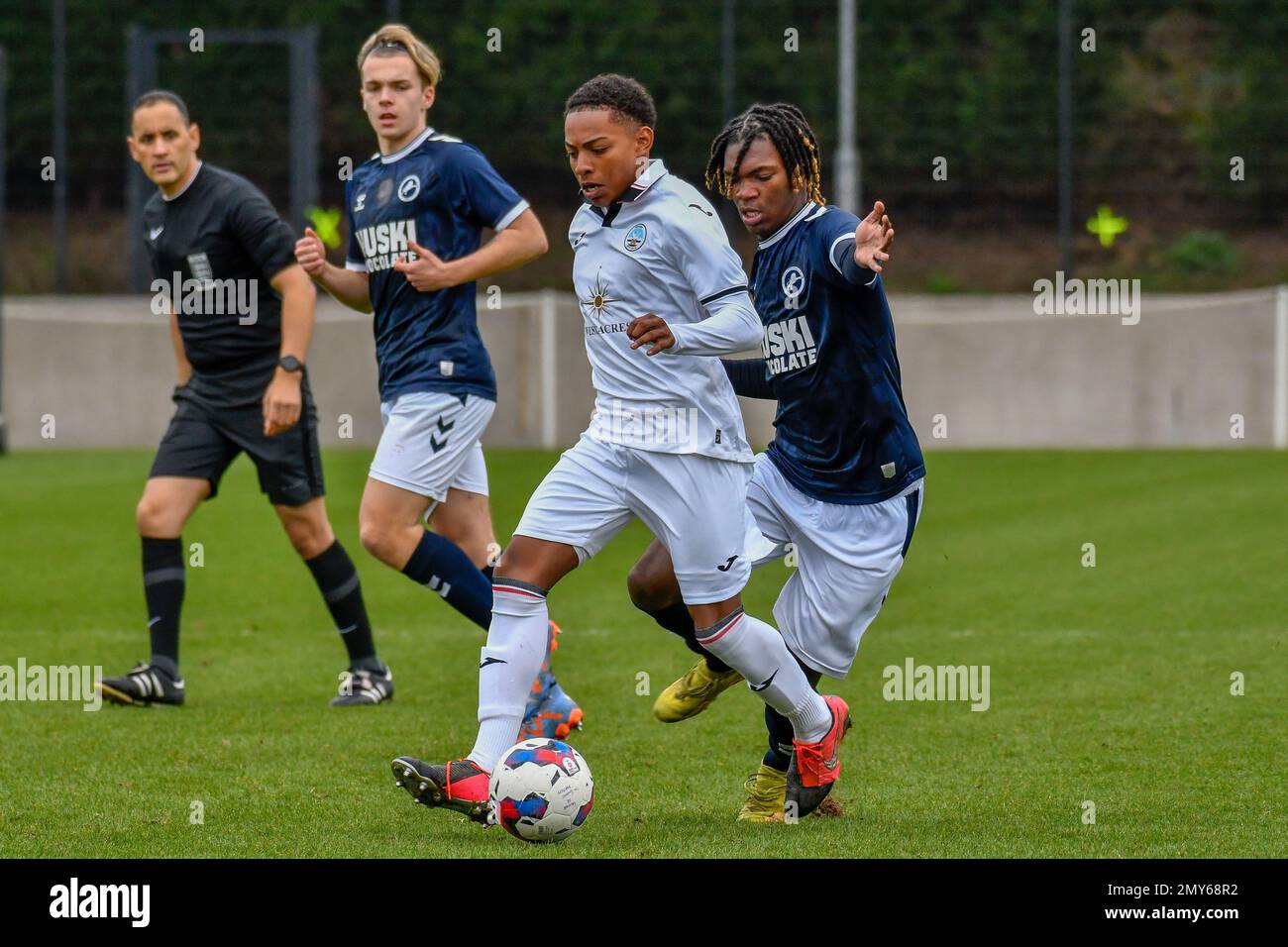 Swansea, Wales. 4 February 2023. Oliver Evans of Millwall under pressure  from Zane Myers of Swansea City during the Professional Development League  game between Swansea City Under 18 and Millwall Under 18