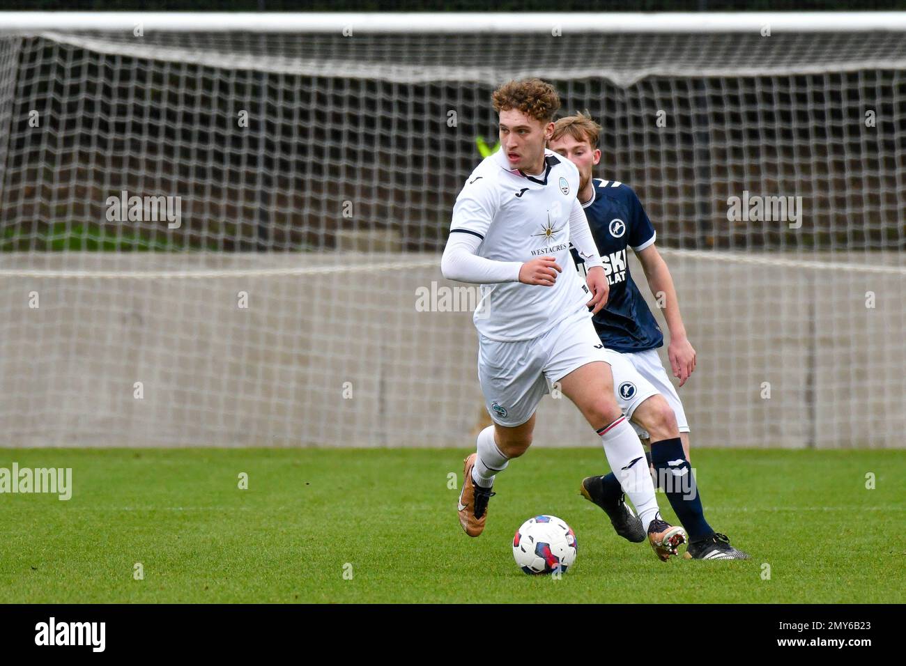 Swansea, Wales. 4 February 2023. Iwan Morgan of Swansea City under pressure from Ernie Cheeseman of Millwall during the Professional Development League game between Swansea City Under 18 and Millwall Under 18 at the Swansea City Academy in Swansea, Wales, UK on 4 February 2023. Credit: Duncan Thomas/Majestic Media. Stock Photo
