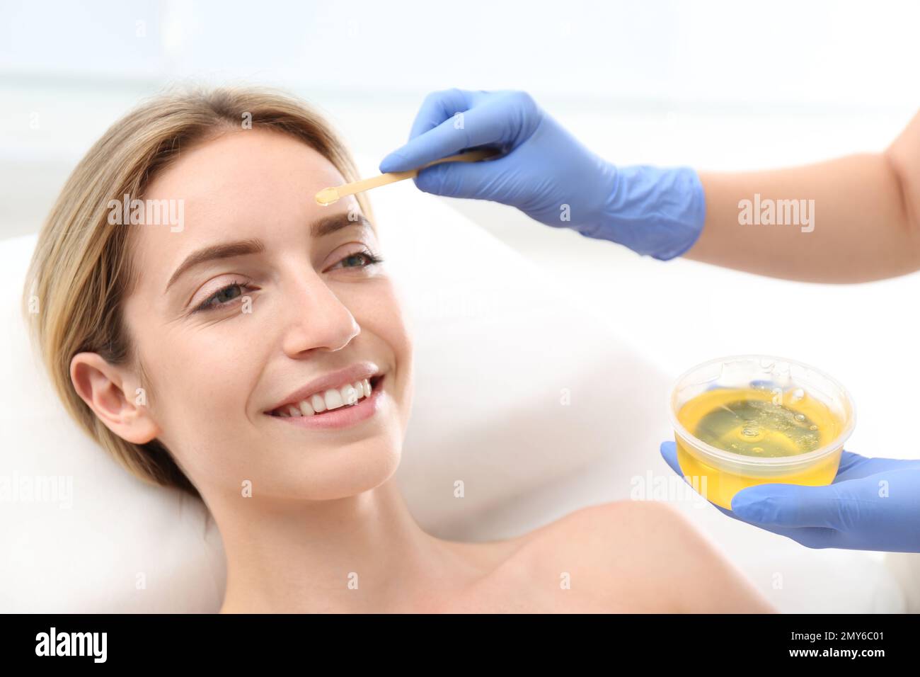 Beautiful woman getting wax epilation of face in salon Stock Photo Alamy