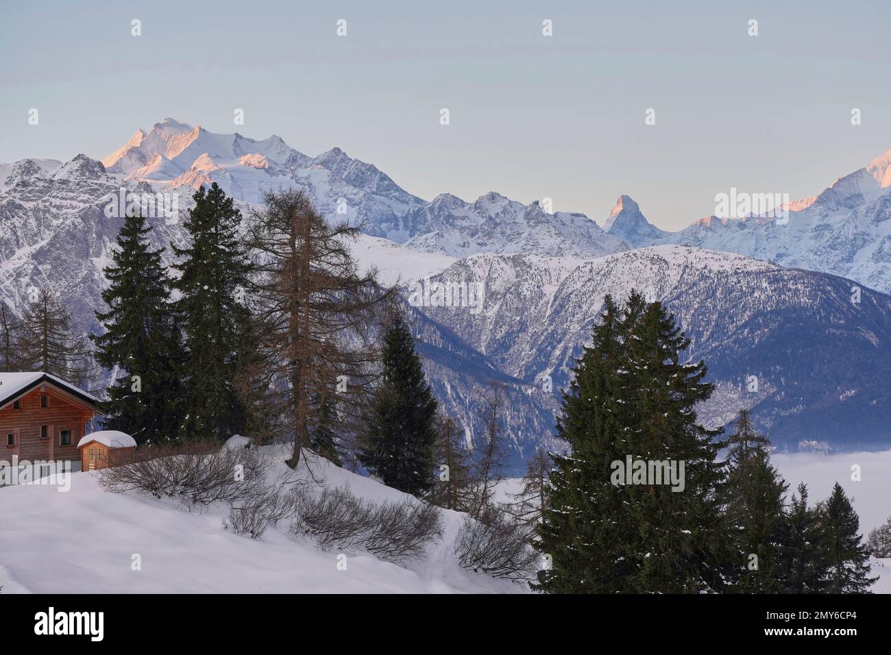A landscape view of the snow-covered area with forest trees and houses ...