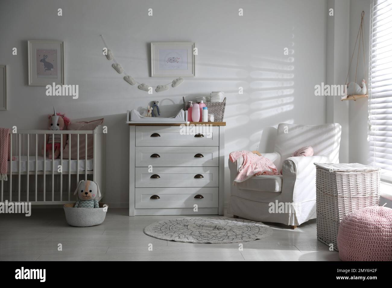 Chest of drawers with changing tray and pad in baby room. Interior