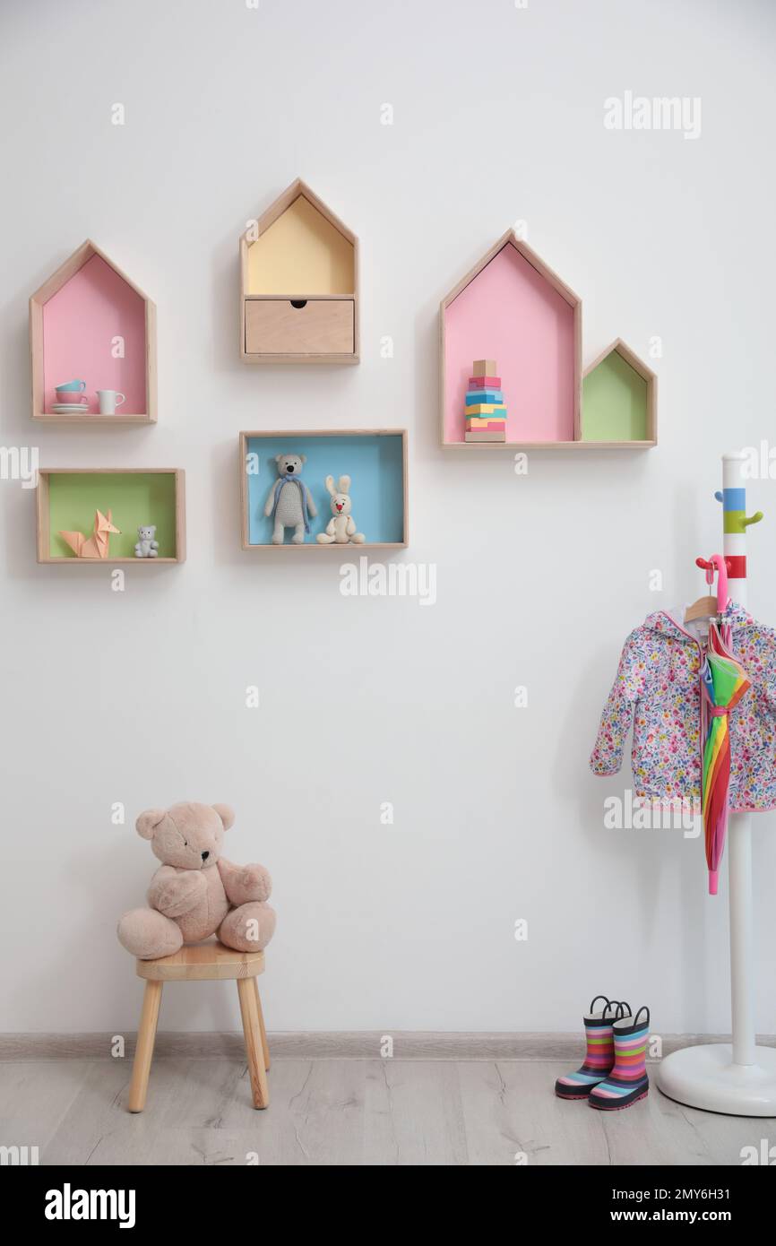 Stylish baby room interior design with house shaped shelves and coat ...