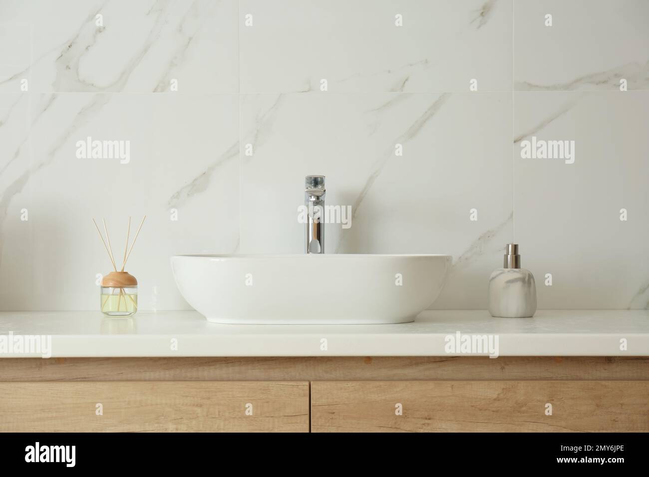 Bathroom counter with sink, soap dispenser and reed air freshener Stock Photo Alamy