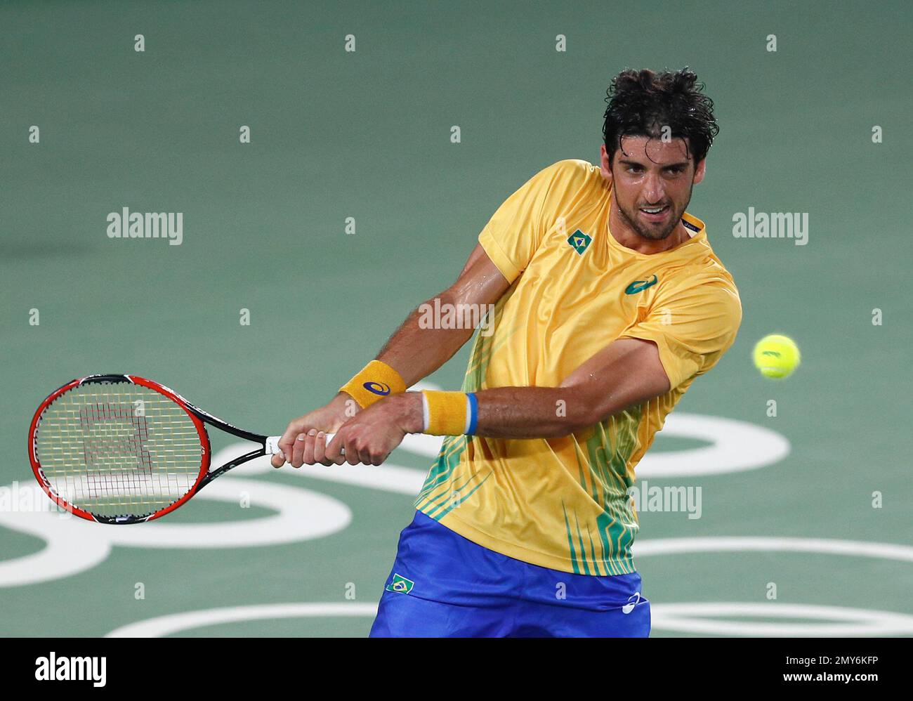 Thomaz Bellucci, of Brazil, returns to Uruguay's Pablo Cuevas in the