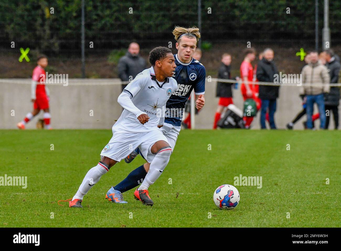 Swansea, Wales. 4 February 2023. Aimar Govea of Swansea City under pressure  from Finley Cotton of Millwall during the Professional Development League  game between Swansea City Under 18 and Millwall Under 18