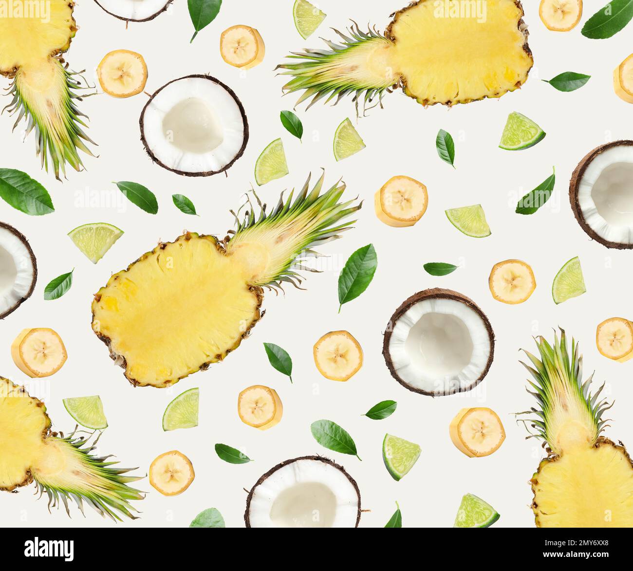 Tropical layout with fresh exotic fruits and green leaves on light ...