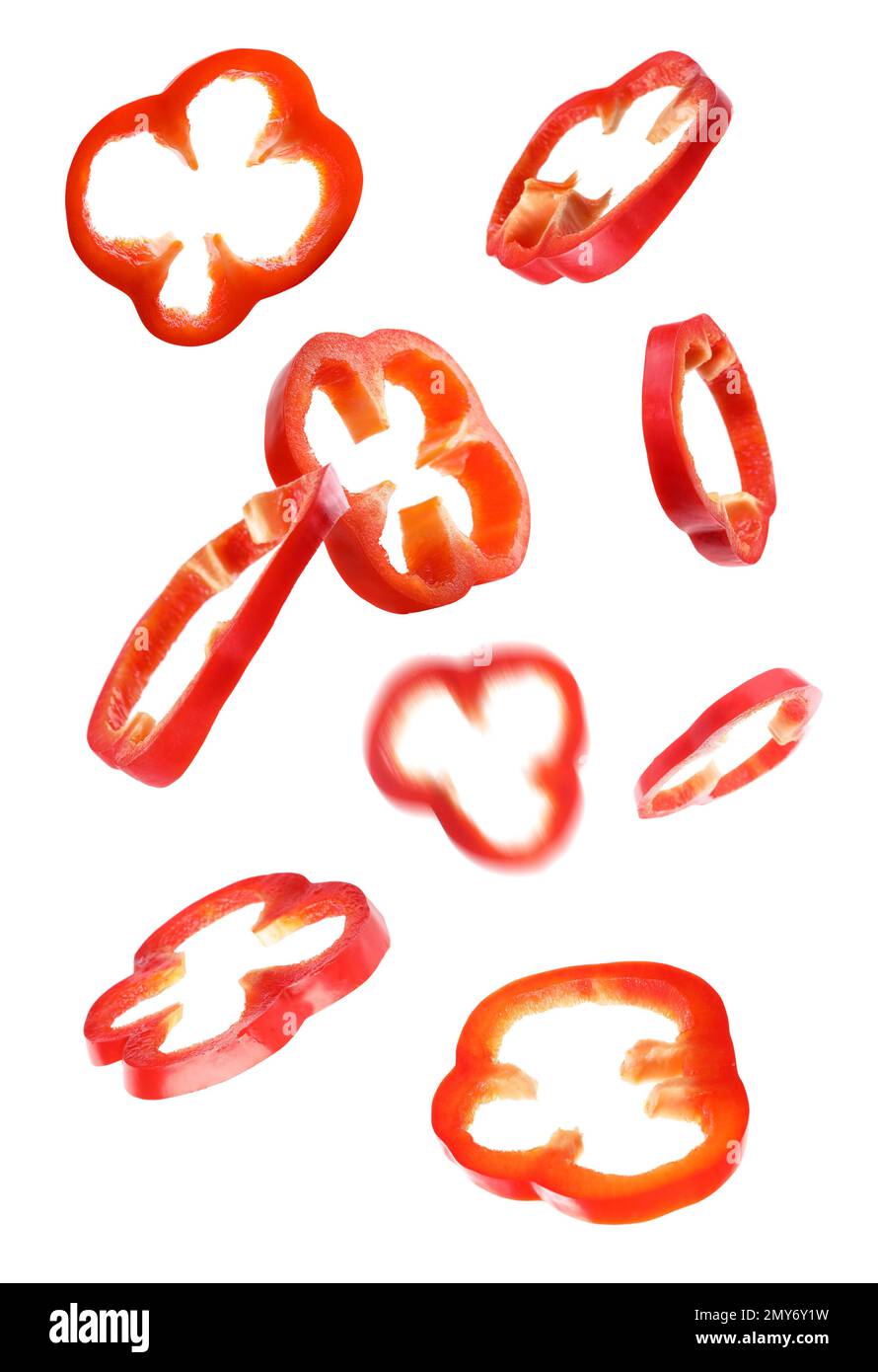 Red bell pepper slices falling on white background Stock Photo Alamy