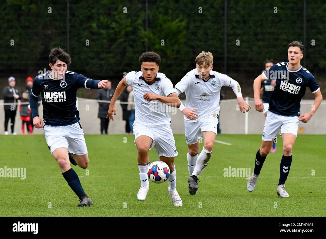 Swansea, Wales. 4 February 2023. Zane Myers of Swansea City under pressure  from Oliver Evans of Millwall during the Professional Development League  game between Swansea City Under 18 and Millwall Under 18