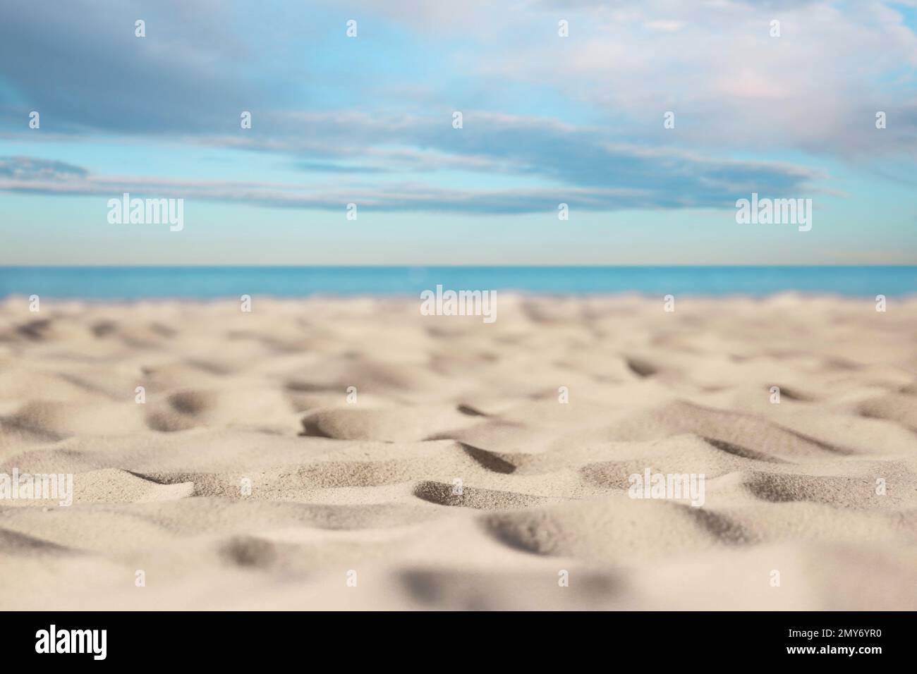 Sandy beach near sea under blue sky with clouds Stock Photo - Alamy