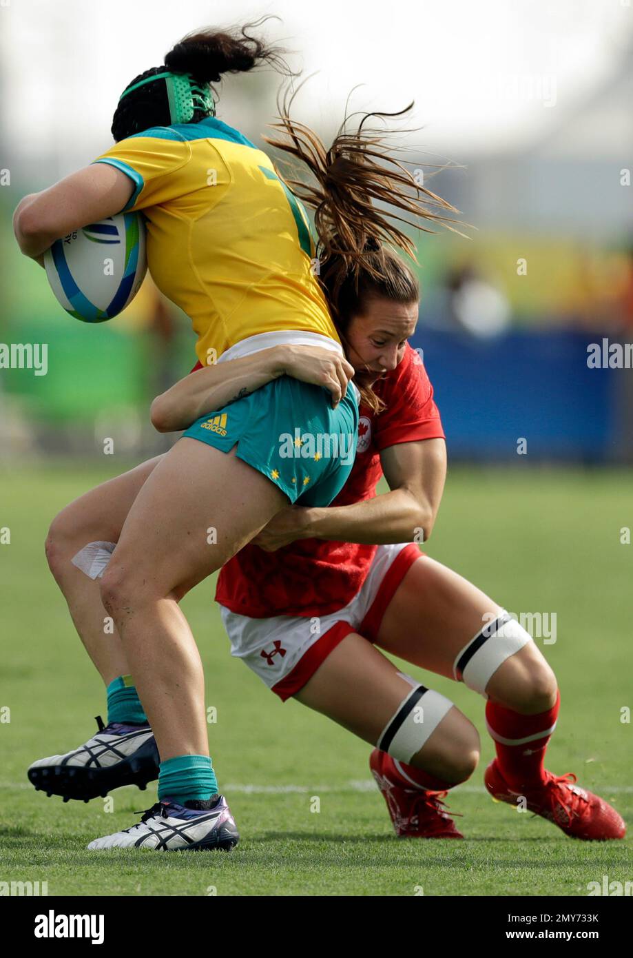 Australias Emilee Cherry, left, is tackled by Canadas Natasha Watcham-Roy, during the womens rugby sevens semi final match at the Summer Olympics in Rio de Janeiro, Brazil, Monday, Aug