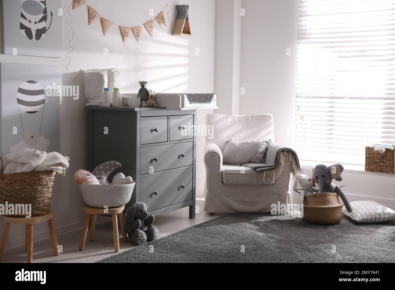 Chest of drawers with changing tray and pad in baby room. Interior ...
