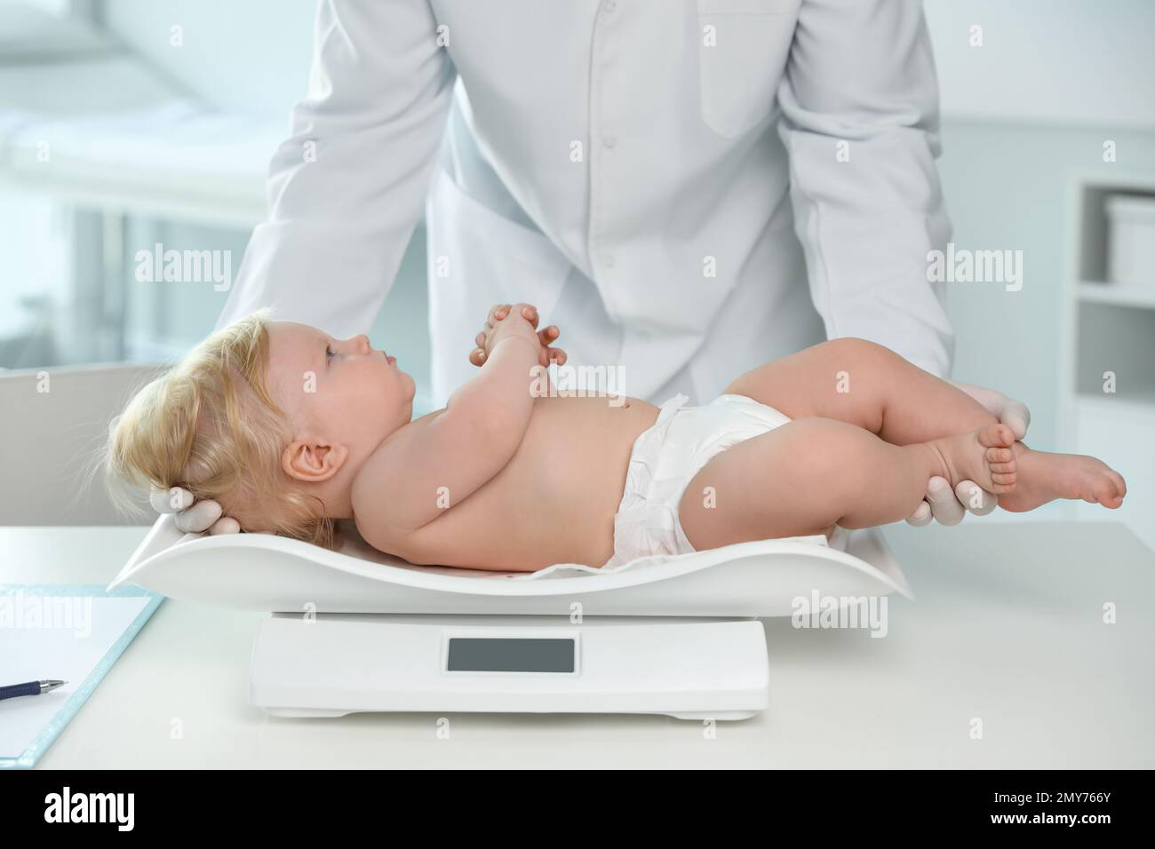 https://c8.alamy.com/comp/2MY766Y/pediatrician-weighting-baby-on-scale-in-hospital-healthy-growth-2MY766Y.jpg