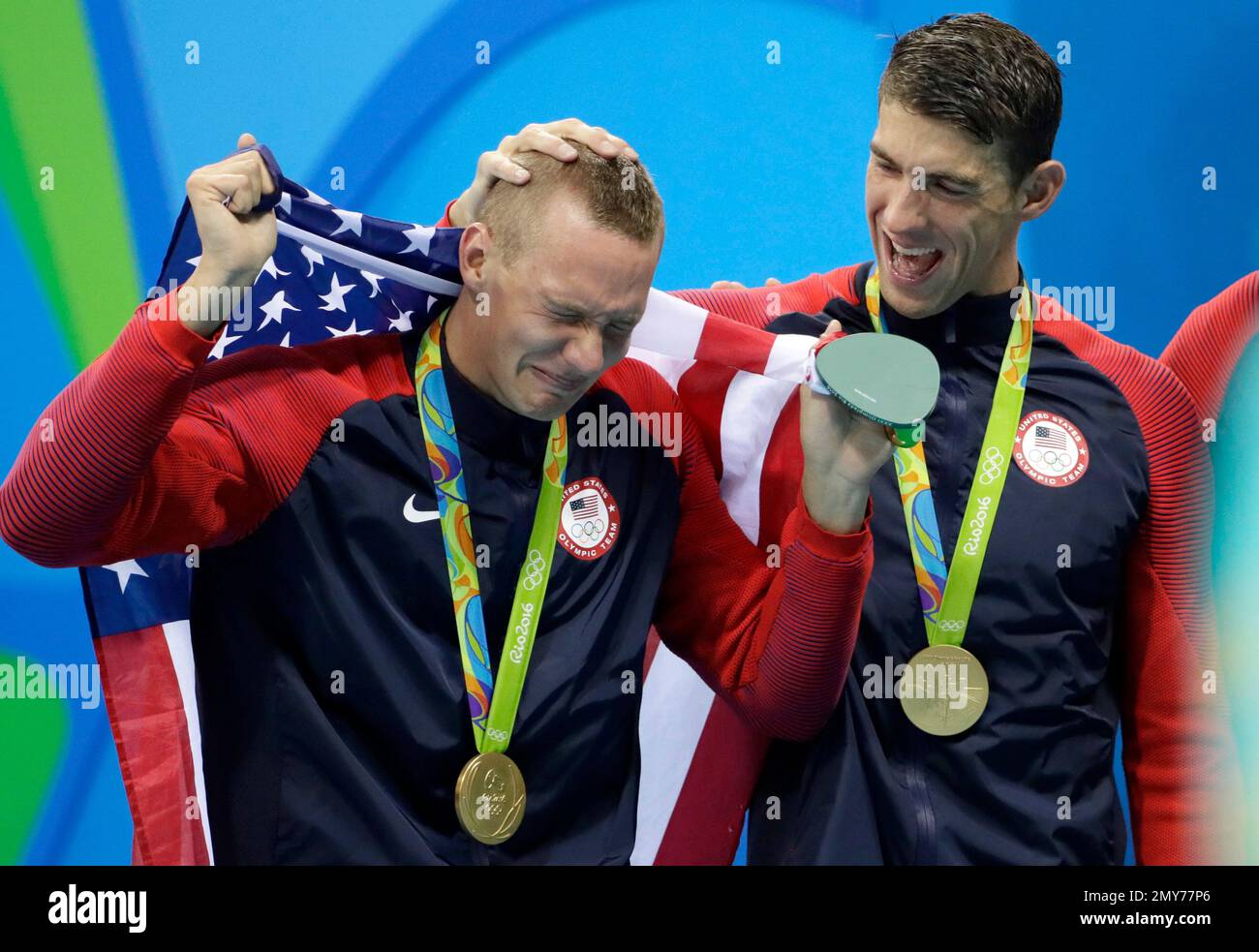Caeleb Dressel, left, cries with Michael Phelps of the United States ...