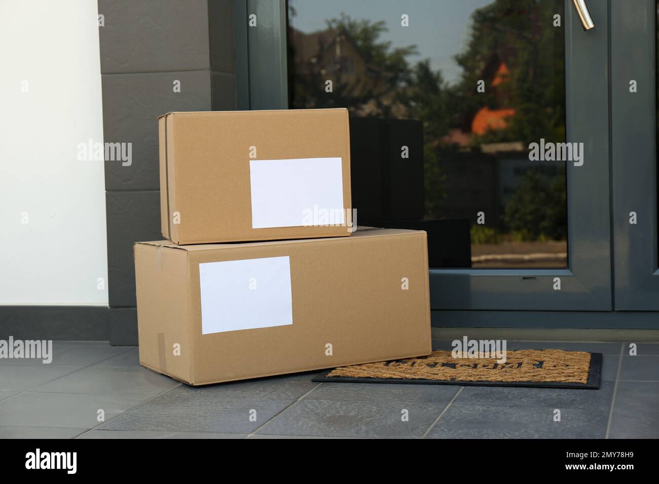 Cardboard boxes near door. Parcel delivery service Stock Photo Alamy