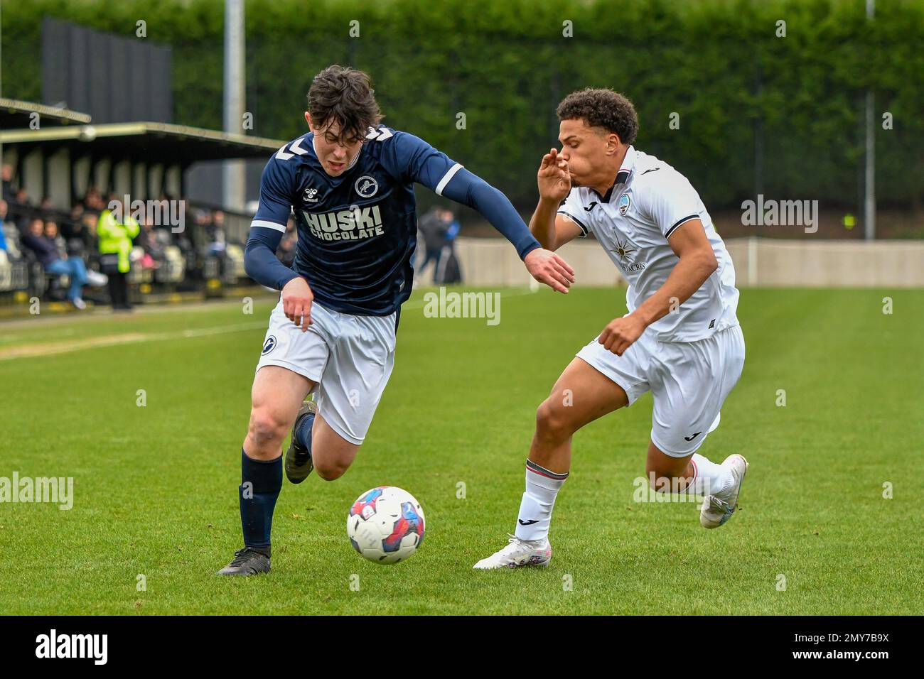 Swansea, Wales. 4 February 2023. Oliver Evans of Millwall under pressure  from Zane Myers of Swansea City during the Professional Development League  game between Swansea City Under 18 and Millwall Under 18