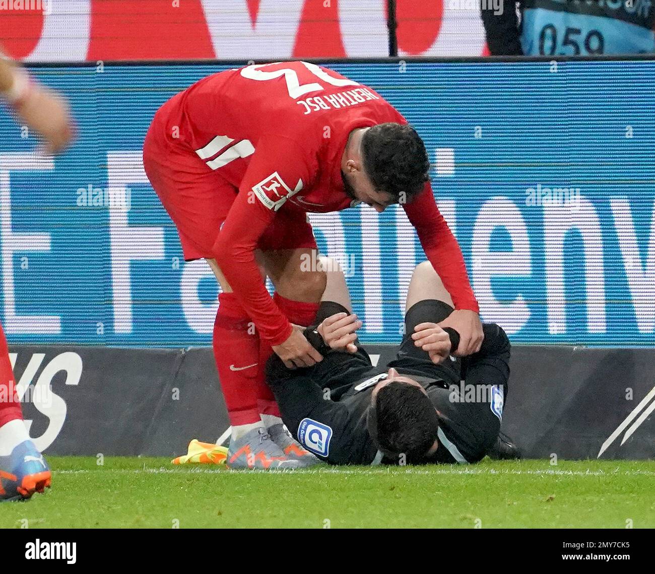 February 4th, 2023, Deutsche Bank Park, Frankfurt, GER, 1st FBL, Eintracht Frankfurt vs Hertha BSC Berlin, DFL regulations prohibit any use of photographs as image sequences and/or quasi-video. in the picture linesman Stefan Lupp lies dazed on the ground after being hit in the head by a ball. Stock Photo