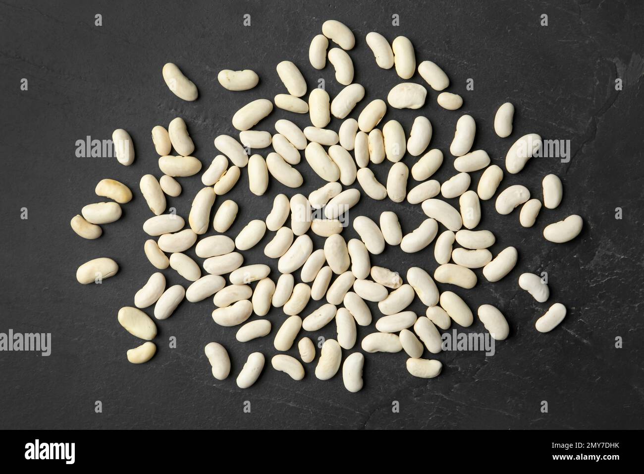 Raw beans on black background, flat lay. Vegetable seeds Stock Photo ...