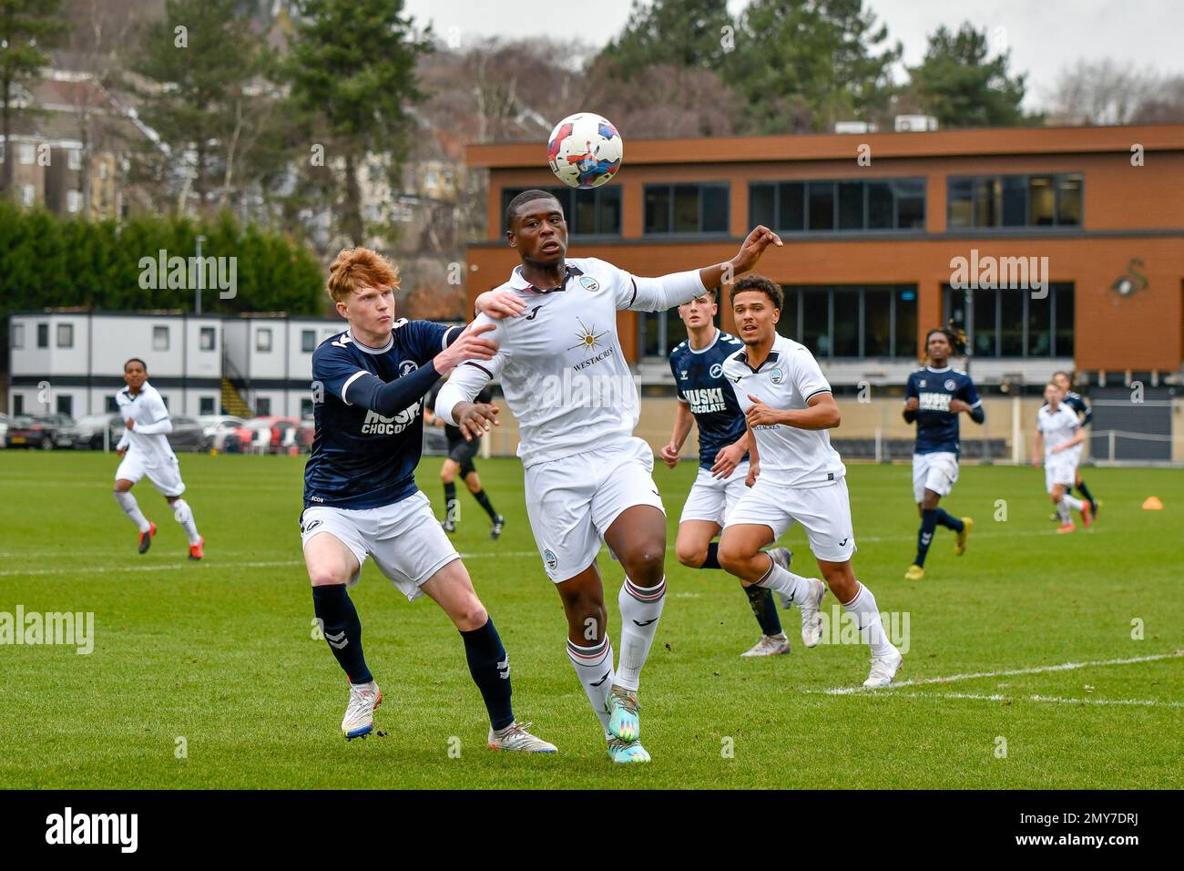 Swansea, Wales. 4 February 2023. Geoffroy Bony of Swansea City battles for  possession with Kyron Horsley-McKay of Millwall during the Professional  Development League game between Swansea City Under 18 and Millwall Under