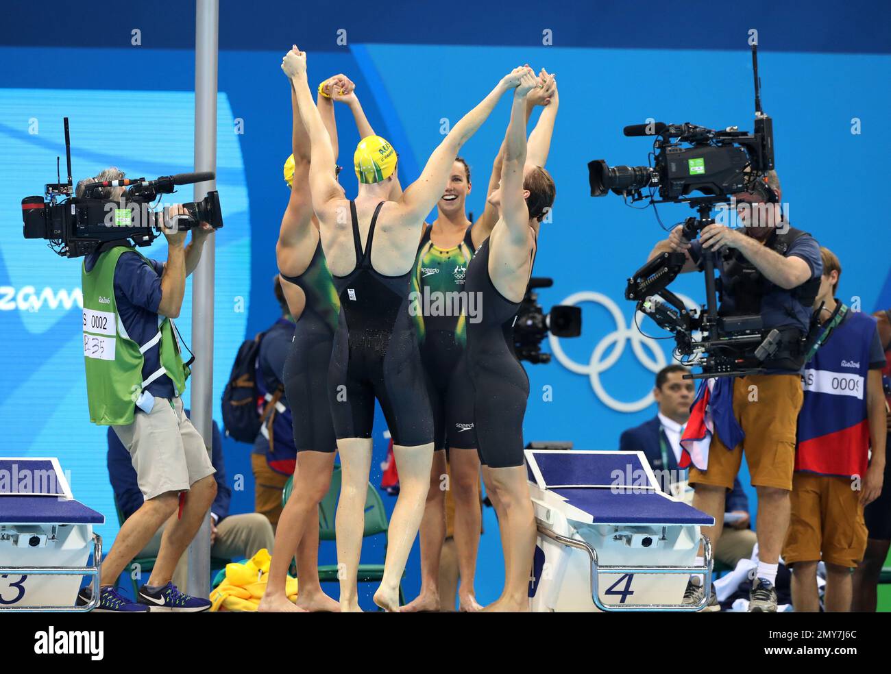 Australia teammates celebrate winning the gold in the women's 4x100