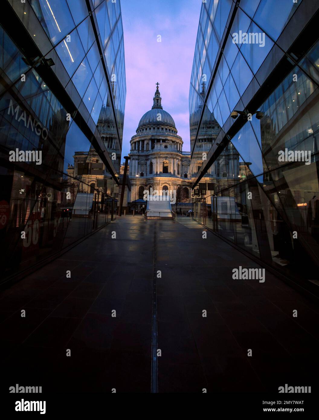 St Pauls Cathedral with the Glass Refelction from the shop at One New Change Shopping Area during sunset Stock Photo