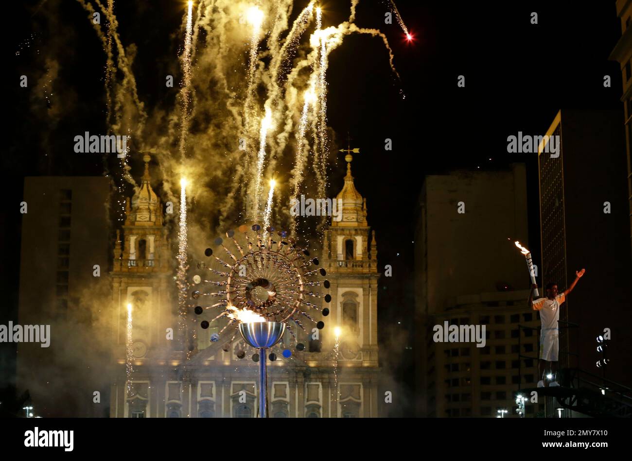 Fireworks explode after Jorge Alberto Oliveira Gomes, right, lighted ...